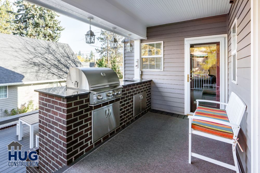 Cozy residential porch with upgrades including a built-in barbecue grill, comfortable seating, and thoughtful remodels and additions.