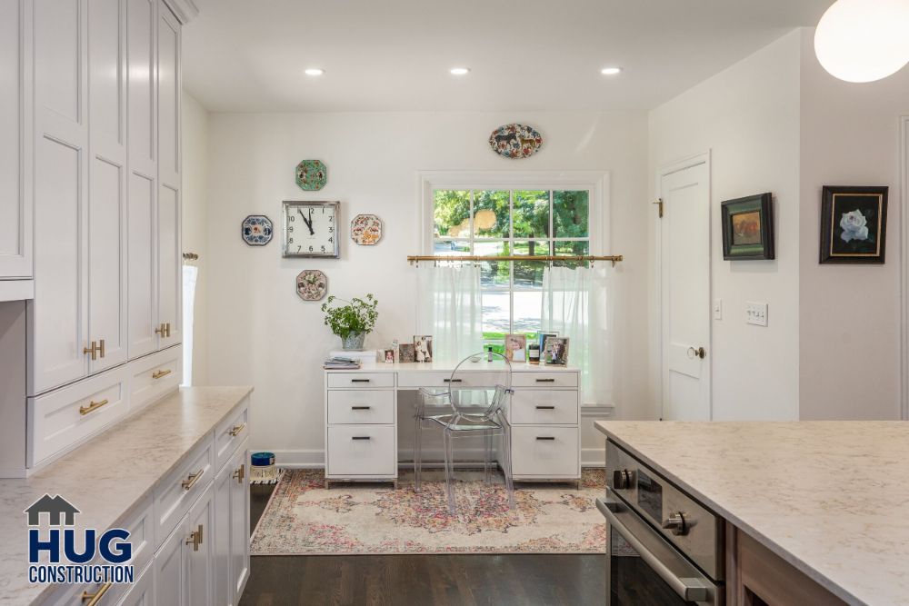 Elegant kitchen nook with remodels and additions, including a small dining area, bright cabinetry, and decorative plates on the wall.