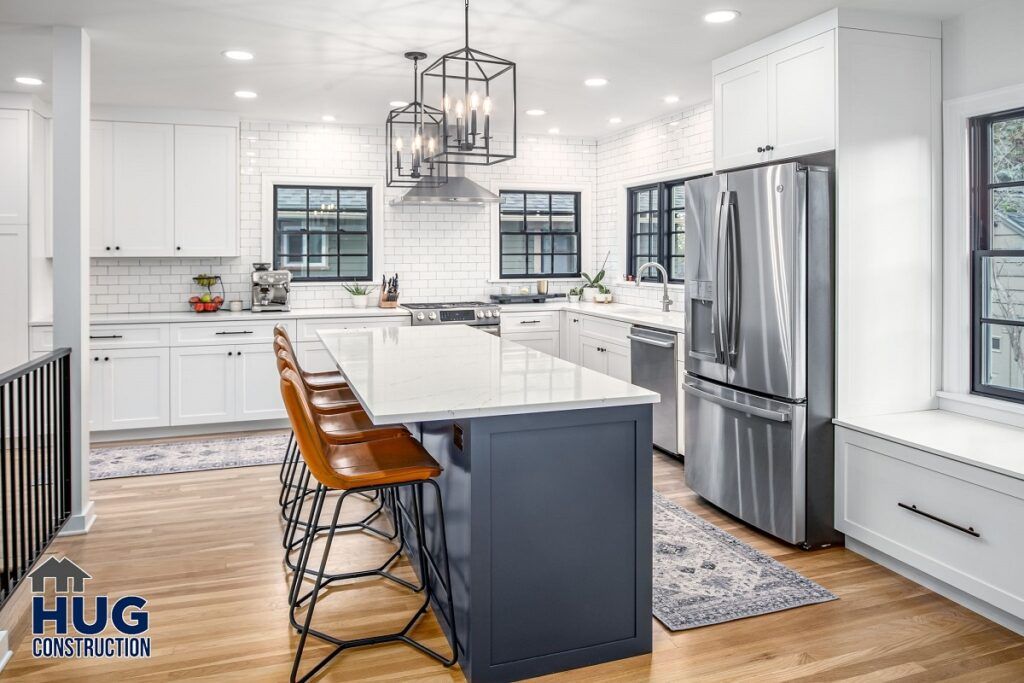 Modern kitchen remodels with white cabinetry, stainless steel appliances, and a central island with bar stools.