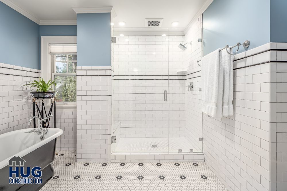 Clean and bright bathroom with a claw-foot tub and walk-in shower, featuring white subway tiles and blue walls, includes recent remodels.