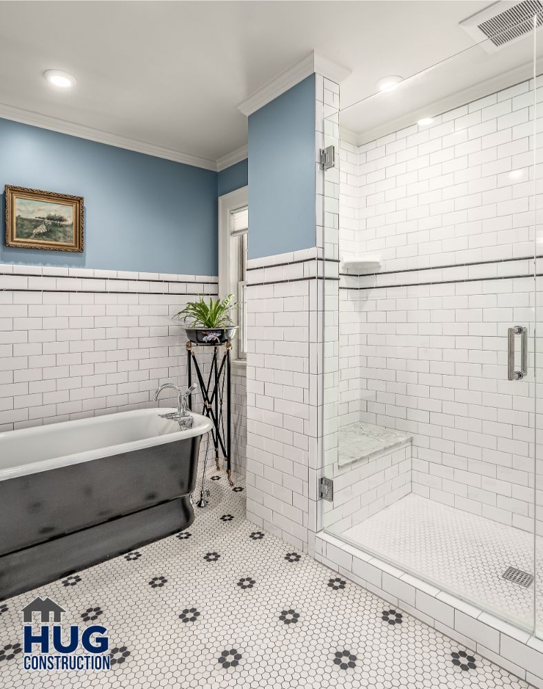 Modern bathroom interior with glass shower enclosure, a freestanding bathtub, and stylish remodels and additions.