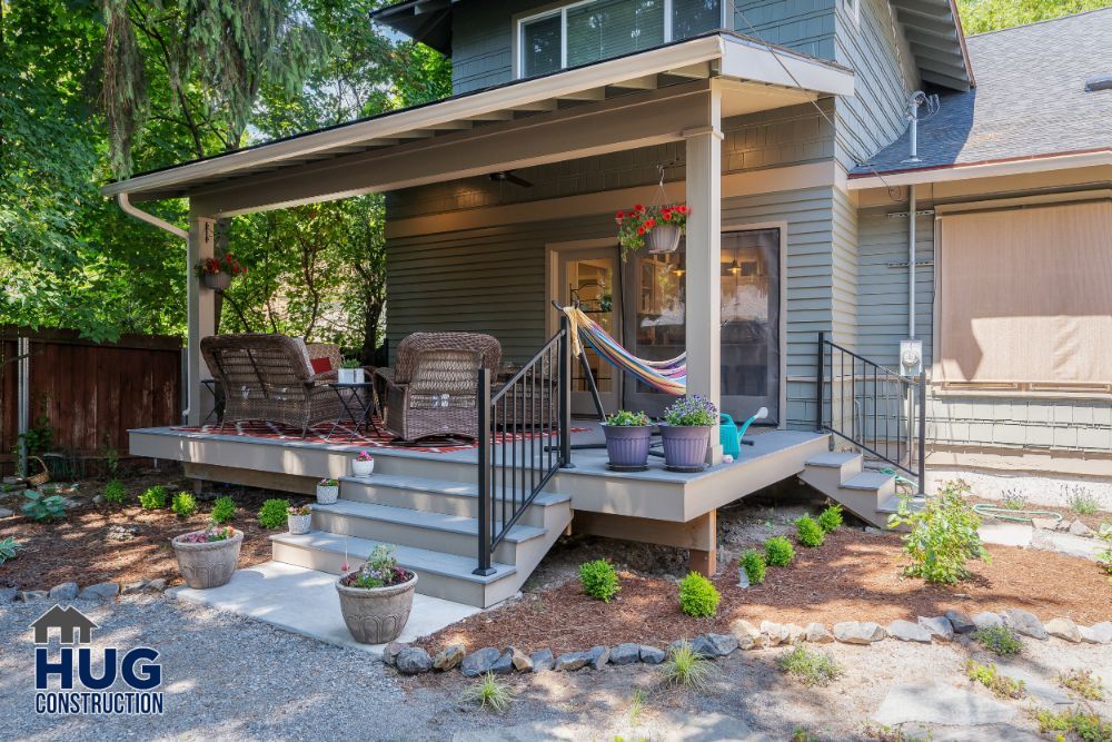 Cozy residential porch with seating and a hammock on a sunny day, enhanced by remodels and additions by hug construction.