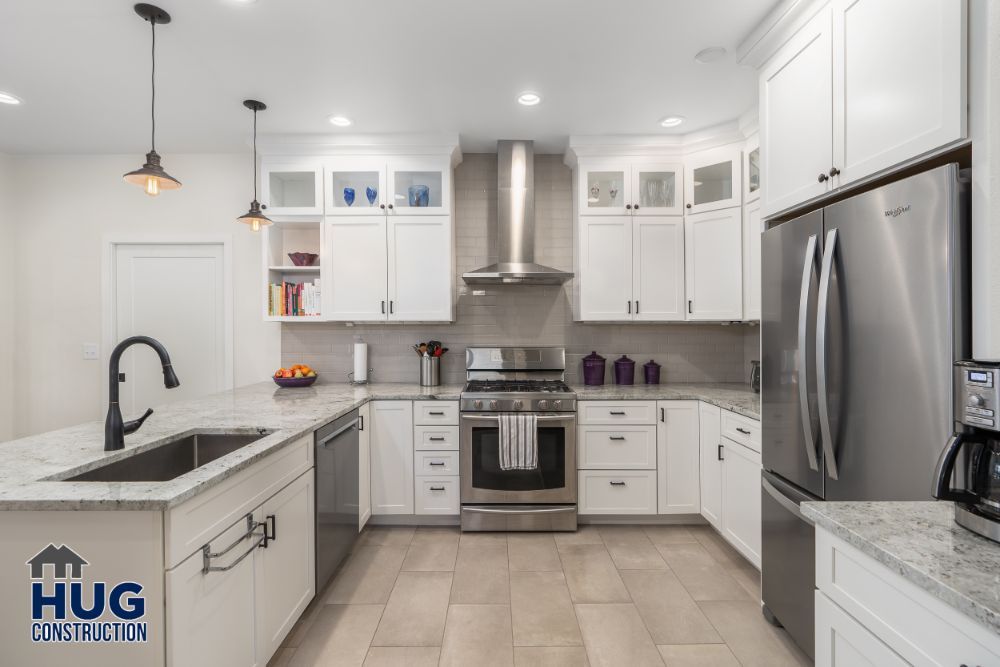 Modern kitchen remodels feature white cabinetry, stainless steel appliances, and marble countertops.