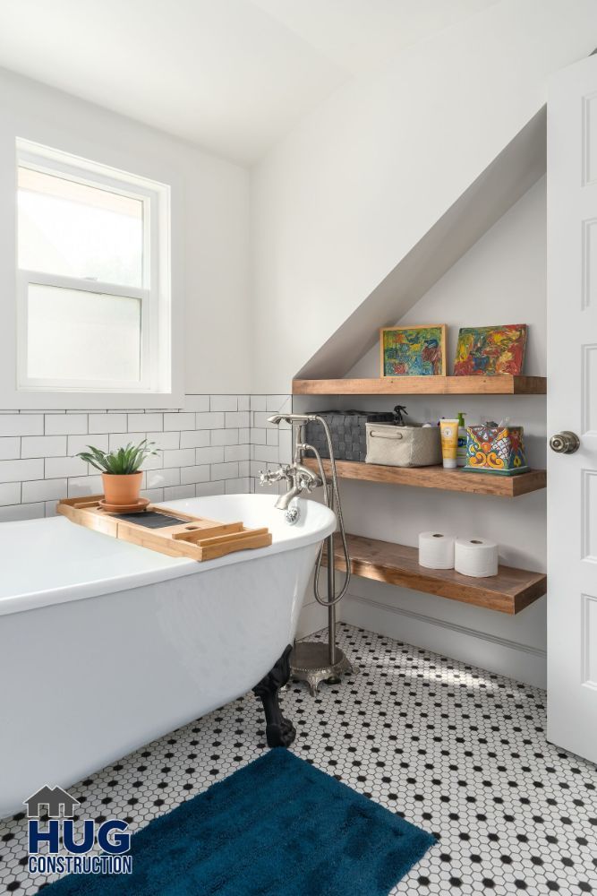 Modern bathroom remodels with clawfoot tub, subway tiles, and sloped ceiling.