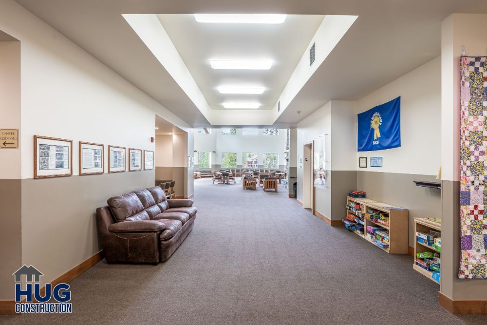 A spacious, well-lit library hall with comfortable seating and bookshelves along the walls, renovated by a leading Commercial Contractor in Spokane.