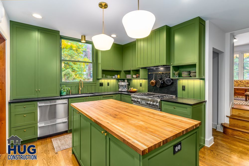 Modern kitchen remodels showcase green cabinets, stainless steel appliances, and a wooden island with additions.