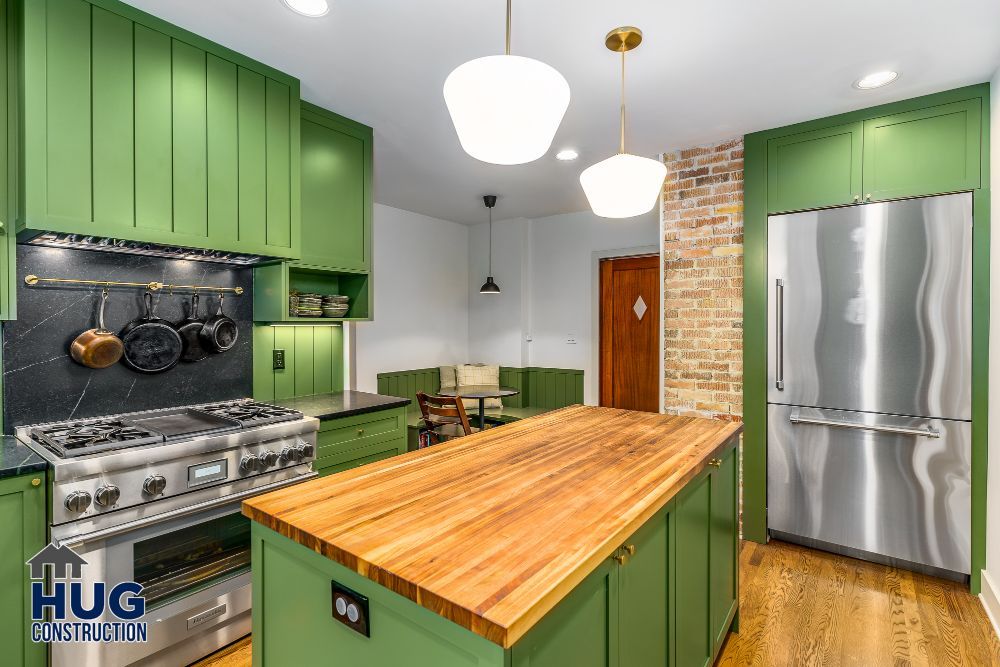 Modern kitchen remodels with green cabinets, stainless steel appliances, and a wooden island.