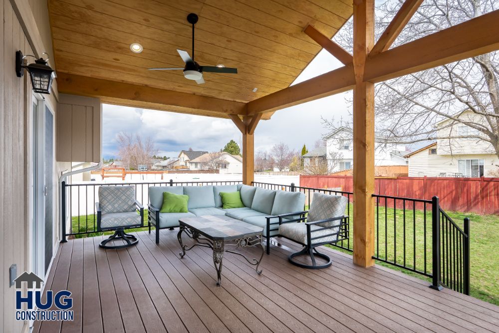 Covered wooden deck with outdoor seating, ceiling fan, and remodels.