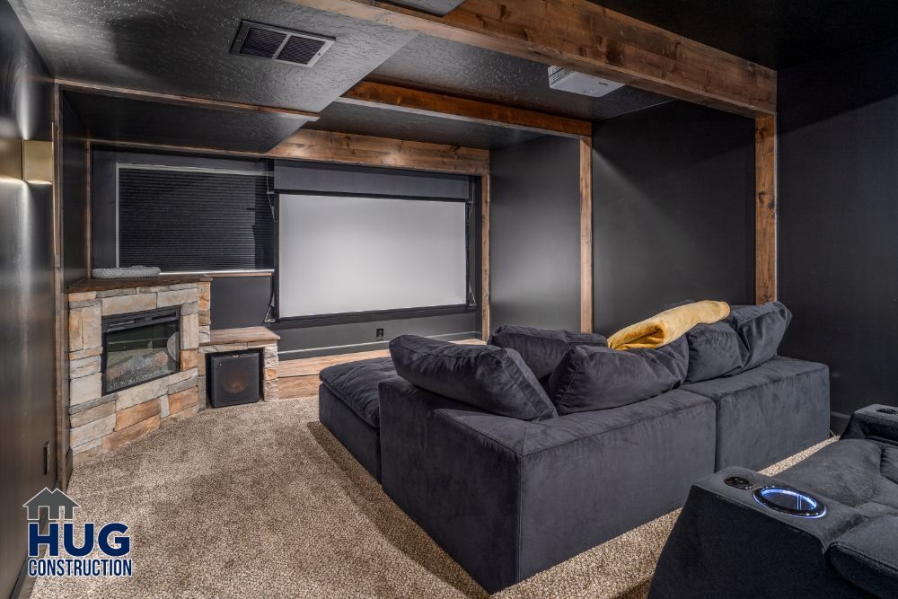 Home theater room with a large screen, comfortable seating, and wood-accented decor, featuring recent remodels and additions.