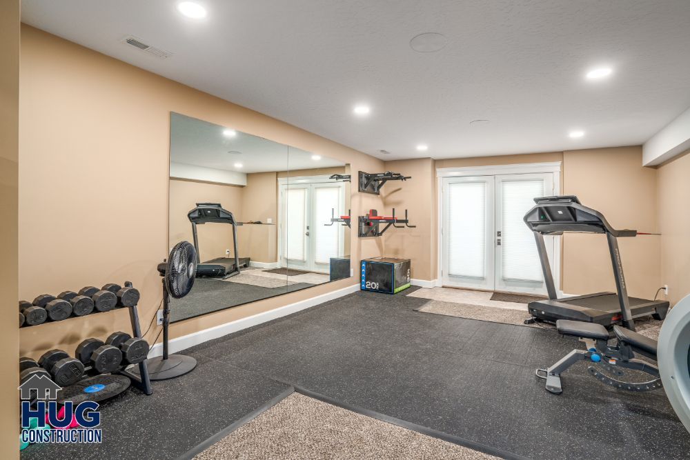 A well-equipped home gym featuring various exercise machines, weights, and recent remodels and additions.