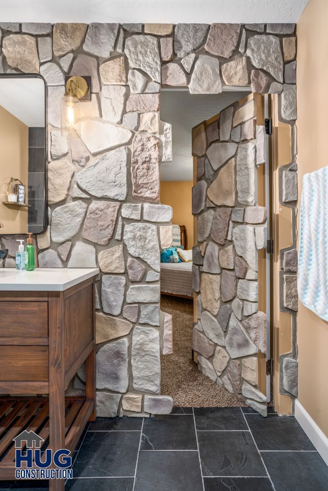 Elegant bathroom remodels featuring a stone archway and wooden vanity.
