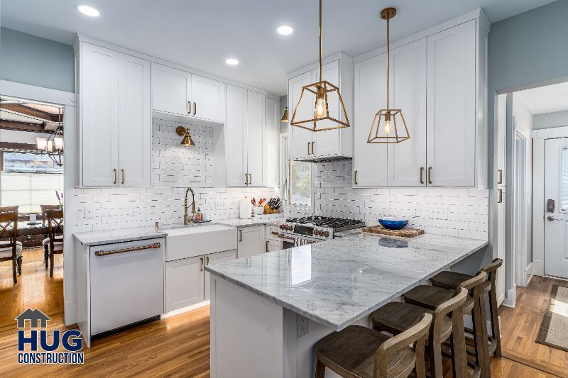 Modern kitchen remodels featuring white cabinetry, marble countertops, and pendant lighting.