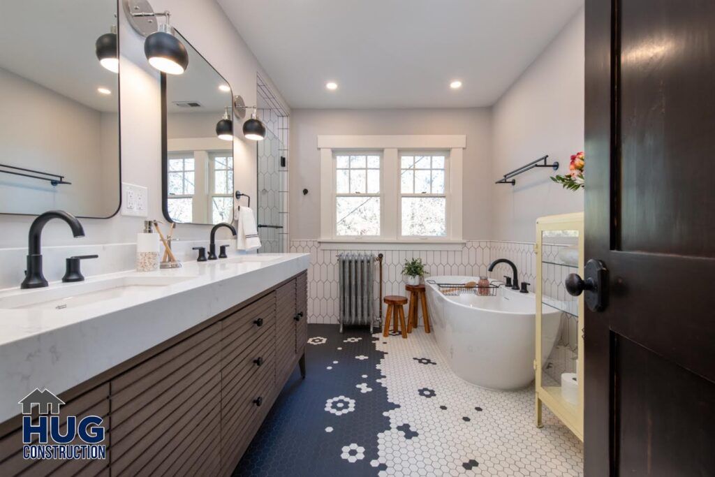 Modern bathroom interior with dual vanity sinks, freestanding tub, hexagonal tile flooring, and remodels.