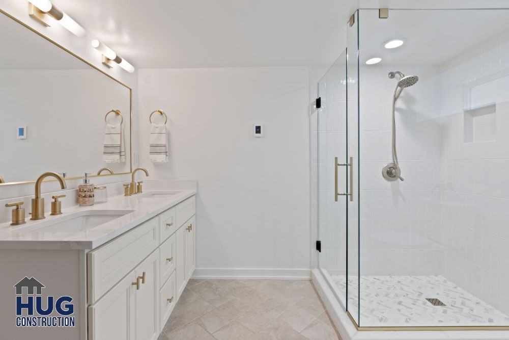 Modern bathroom remodel with double vanity and glass-enclosed shower.