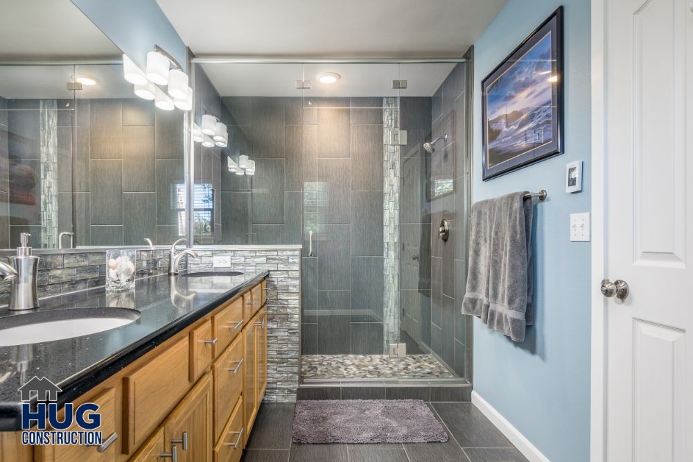 Modern bathroom remodels with a walk-in shower and double vanity.