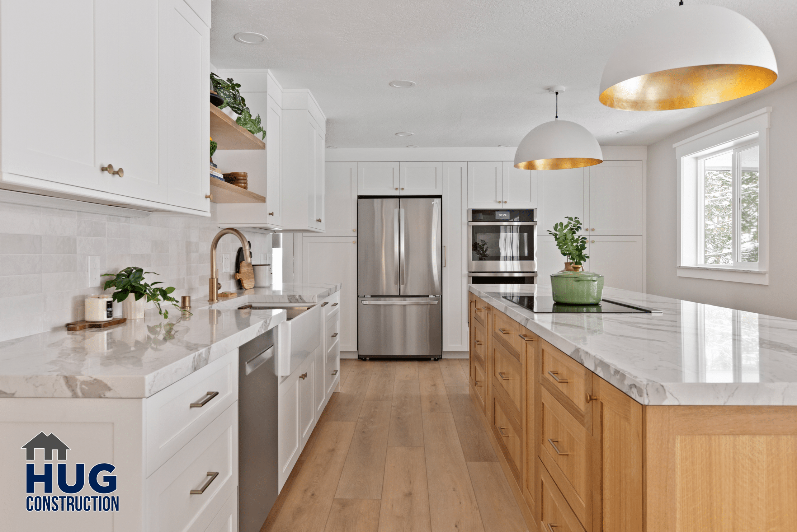Gunning Rd interior remodel: Modern kitchen with white cabinetry, stainless steel appliances, hardwood flooring, and a central island countertop.