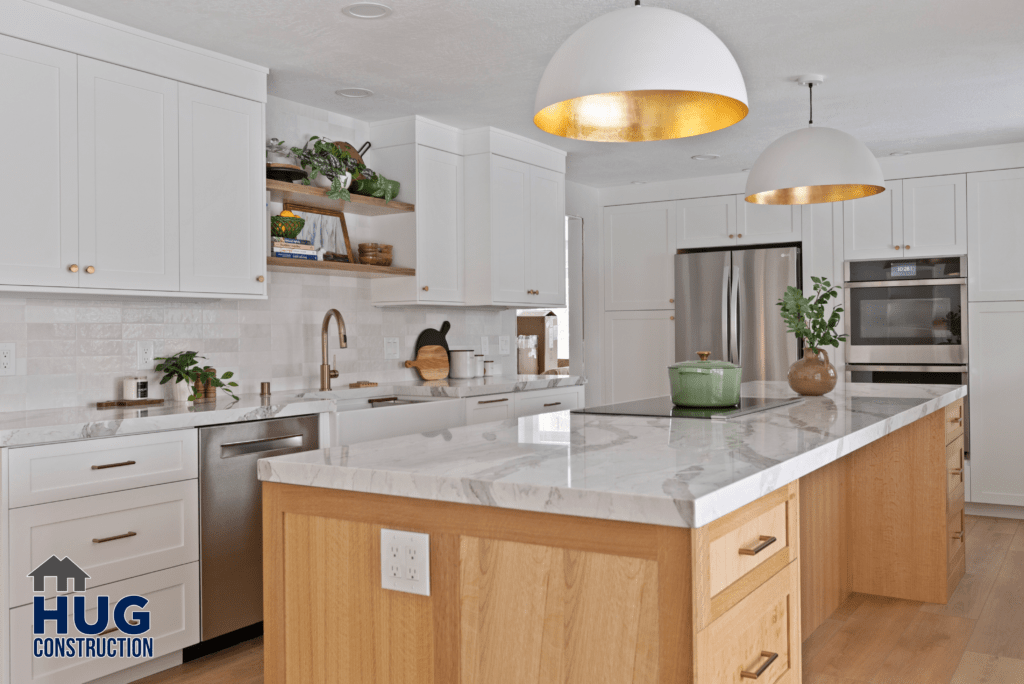 Modern kitchen interior from the Gunning Rd Interior Remodel project, featuring white cabinetry, stainless steel appliances, and a large island with a marble countertop.